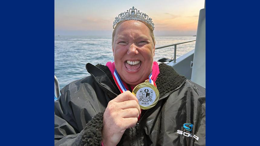 Lindsey Walke with her medal on a boat