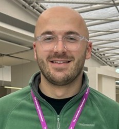 Headshot of a young male PhD student with glasses.