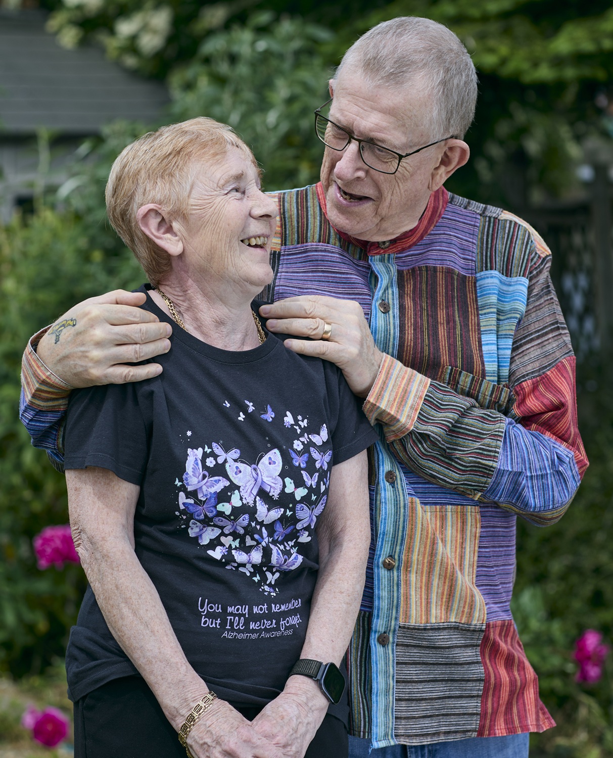 Pete Middleton in the garden with his arms around his wife