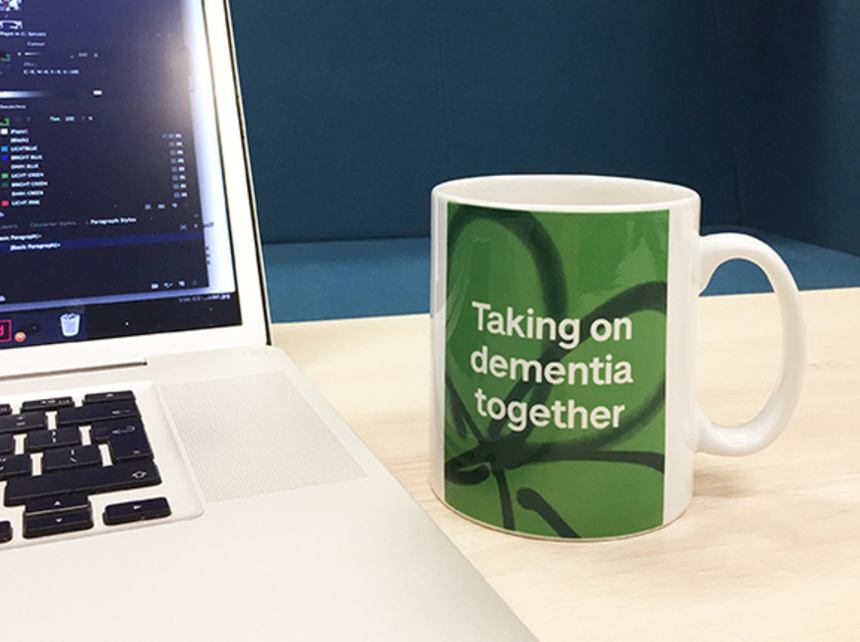 A coffee mug that reads 'Taking on dementia together'