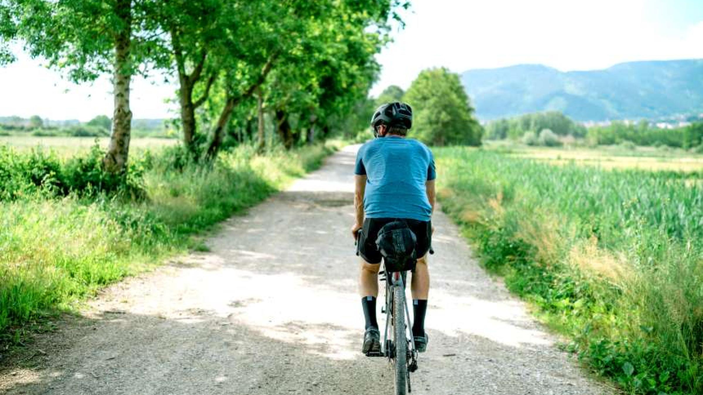 man on bike cycling country lane