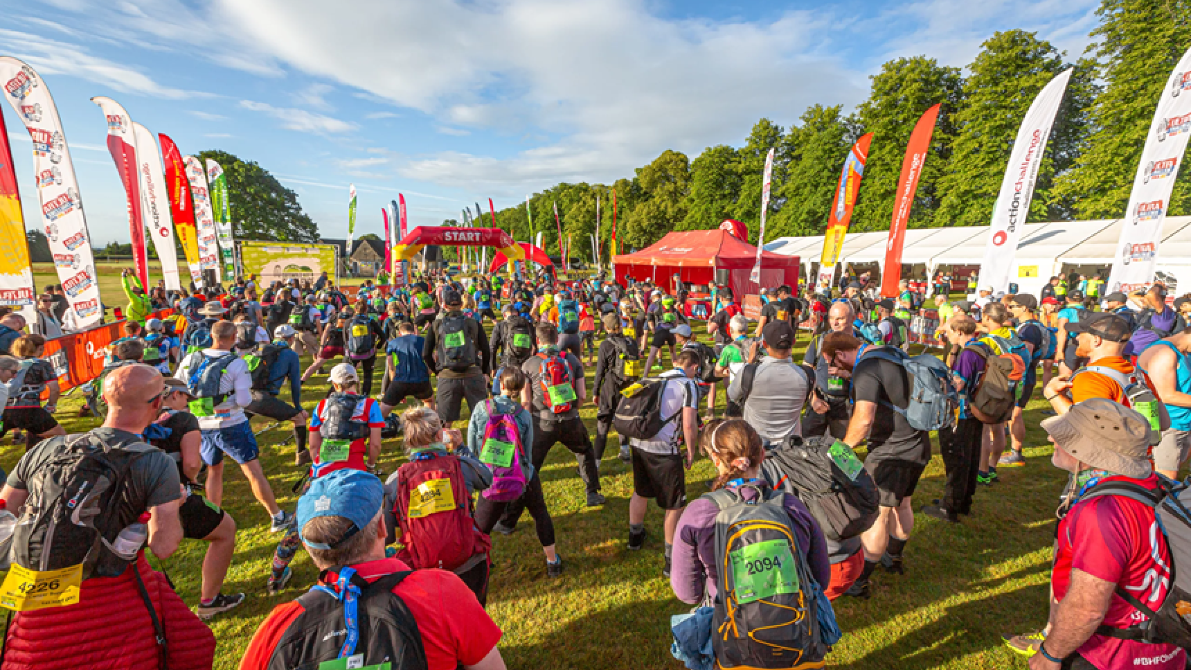 Group of walkers in a field of long grass on the North Downs route