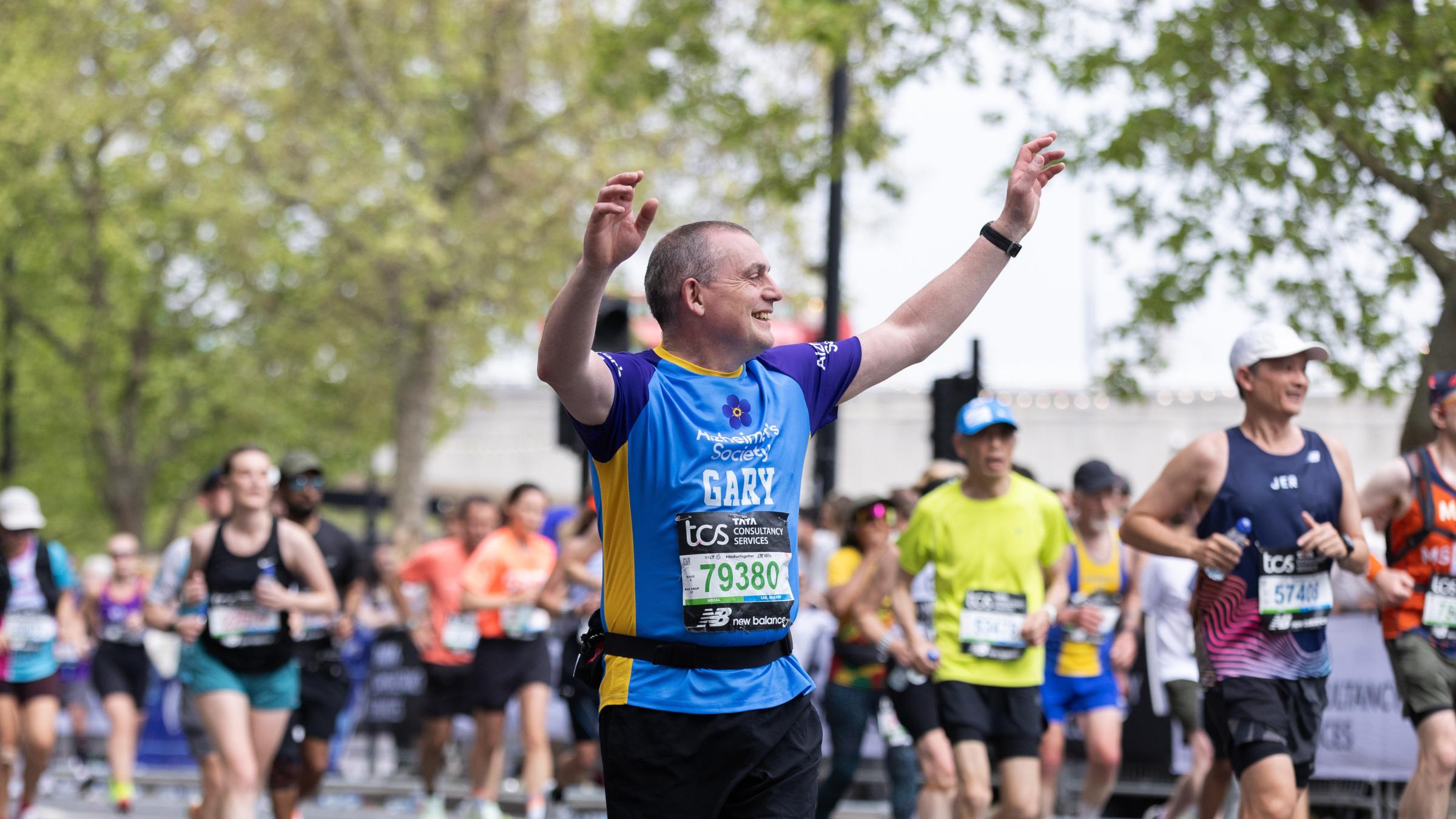 Man running with hands in the air