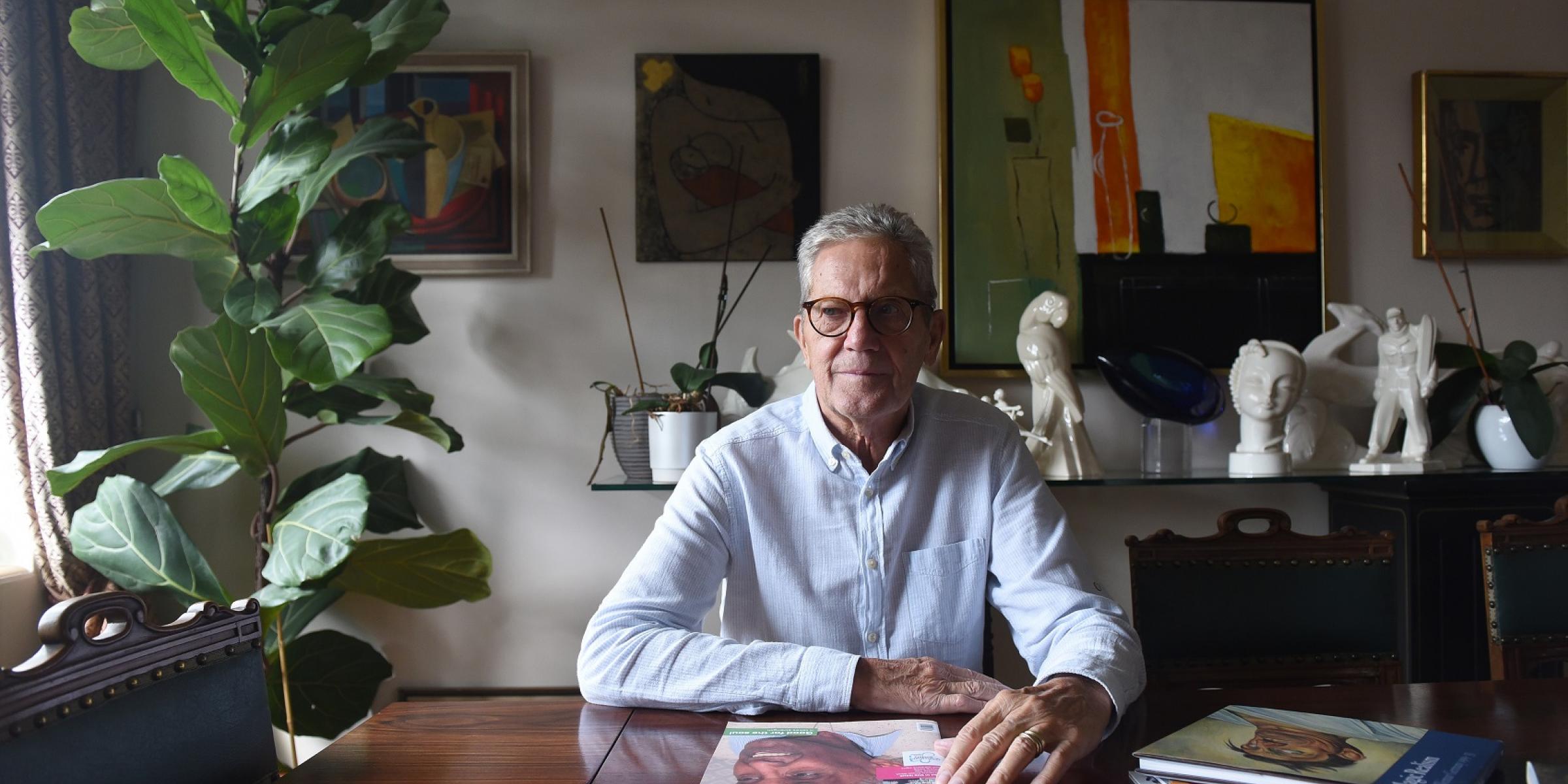 A man sitting at his table at home