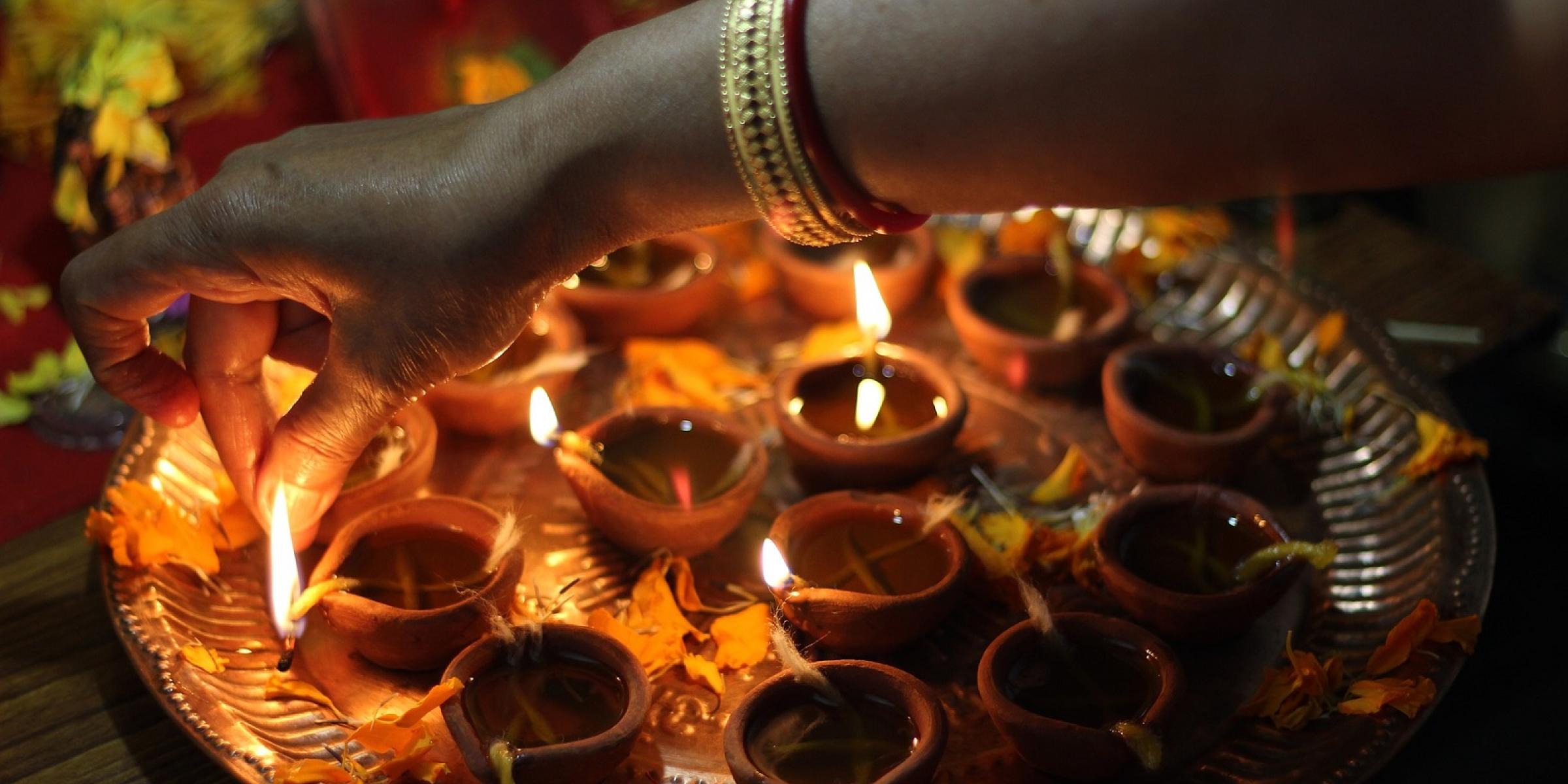 Lighting candles for Diwali