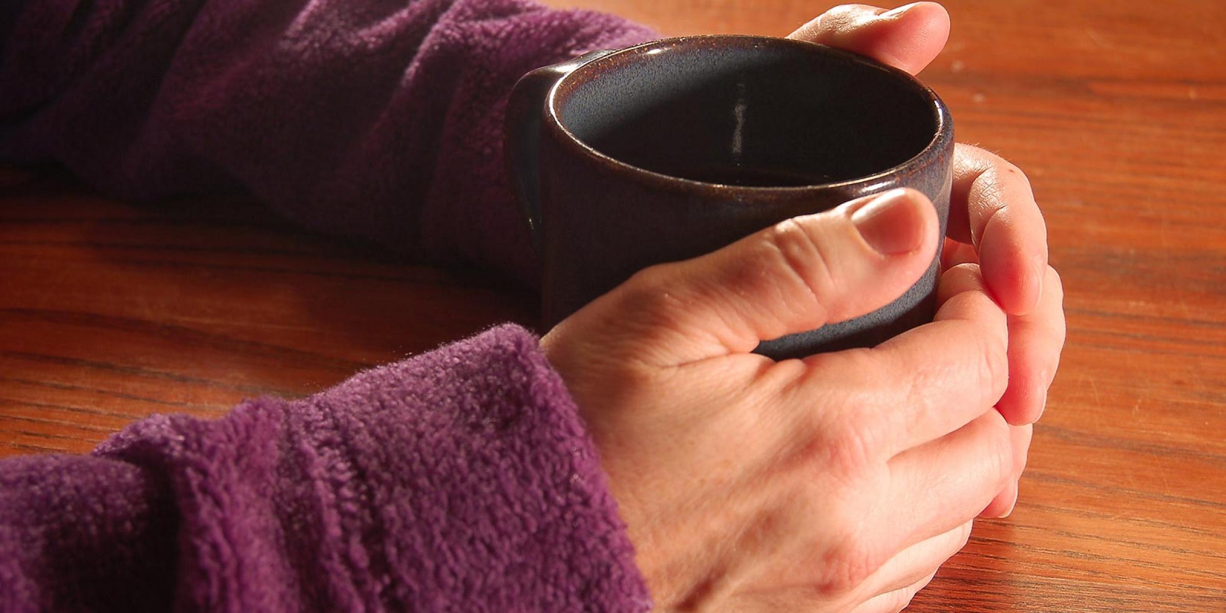 Someone holding a mug of tea