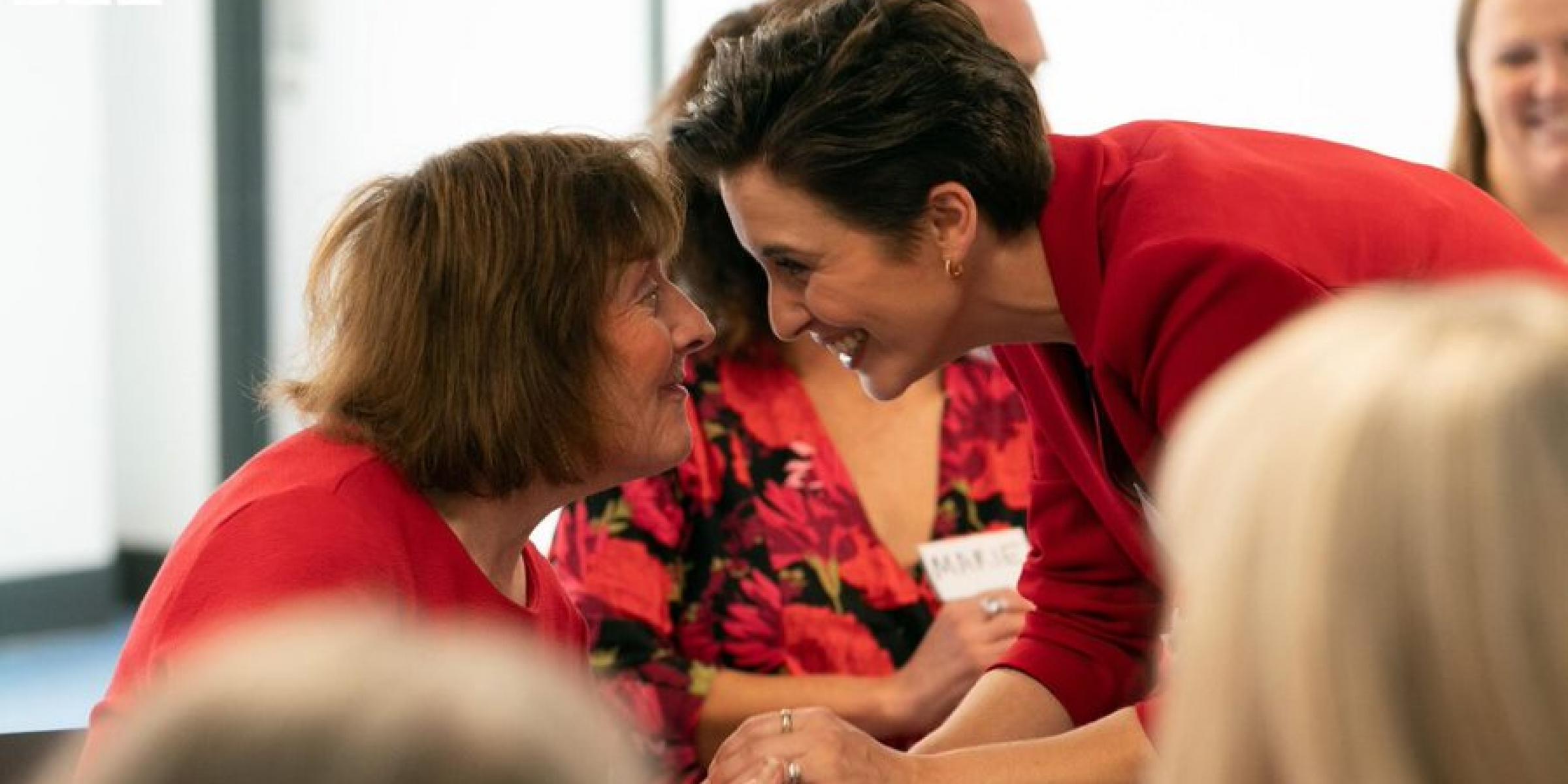 Vick McClure holding hands with a member of the dementia choir