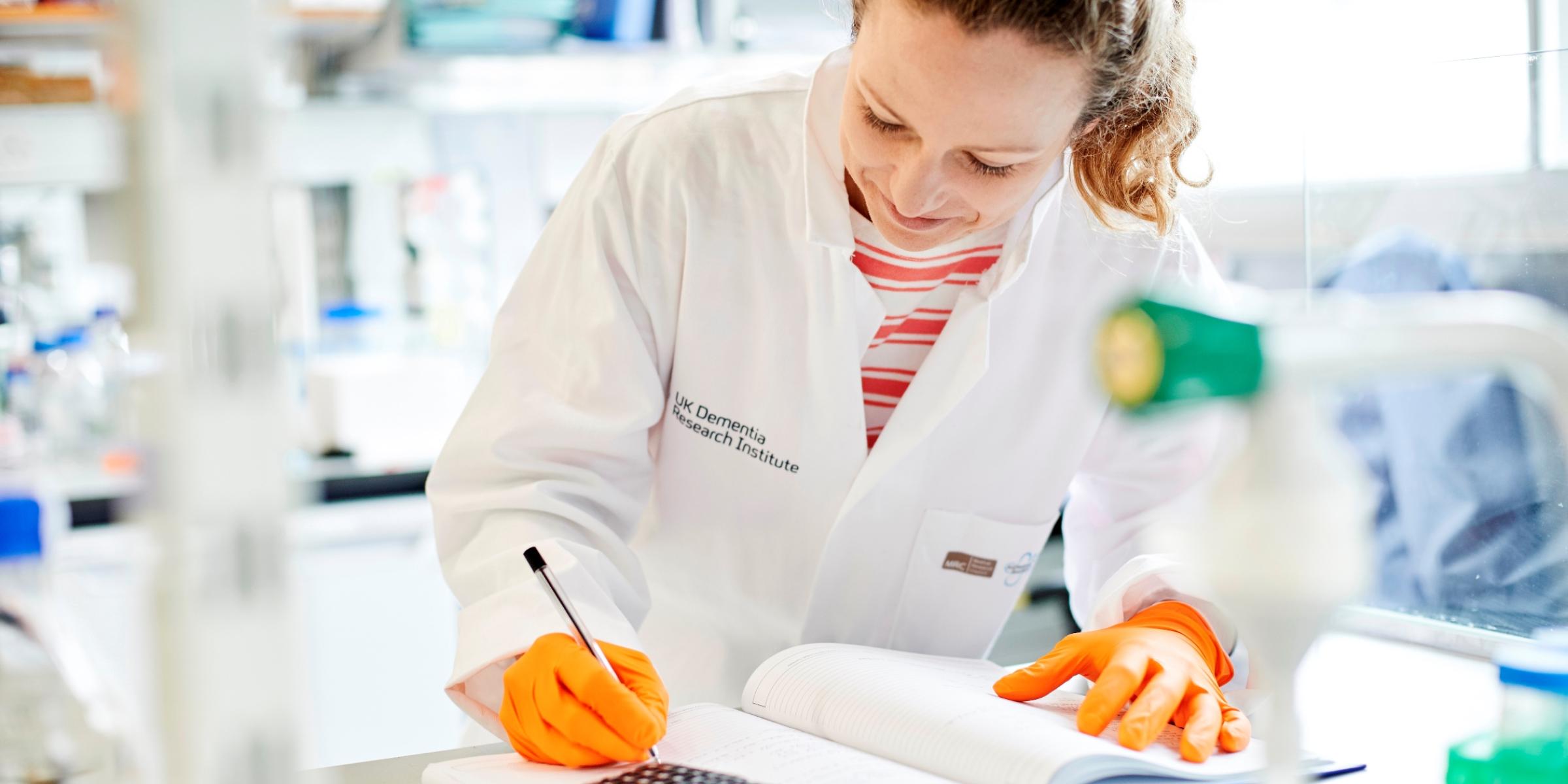 researcher making notes in the lab