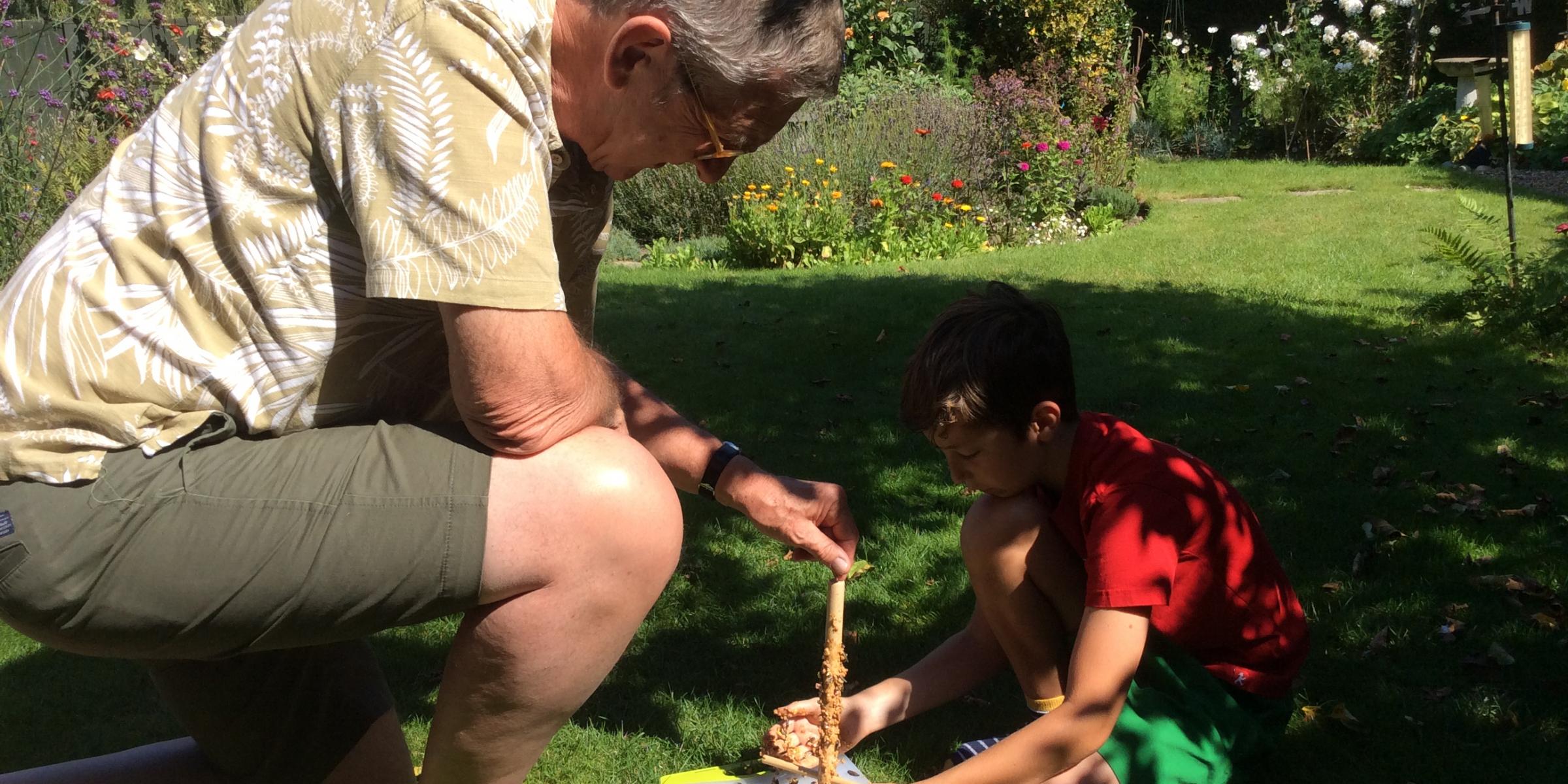 Keith plays in the garden with his grandson