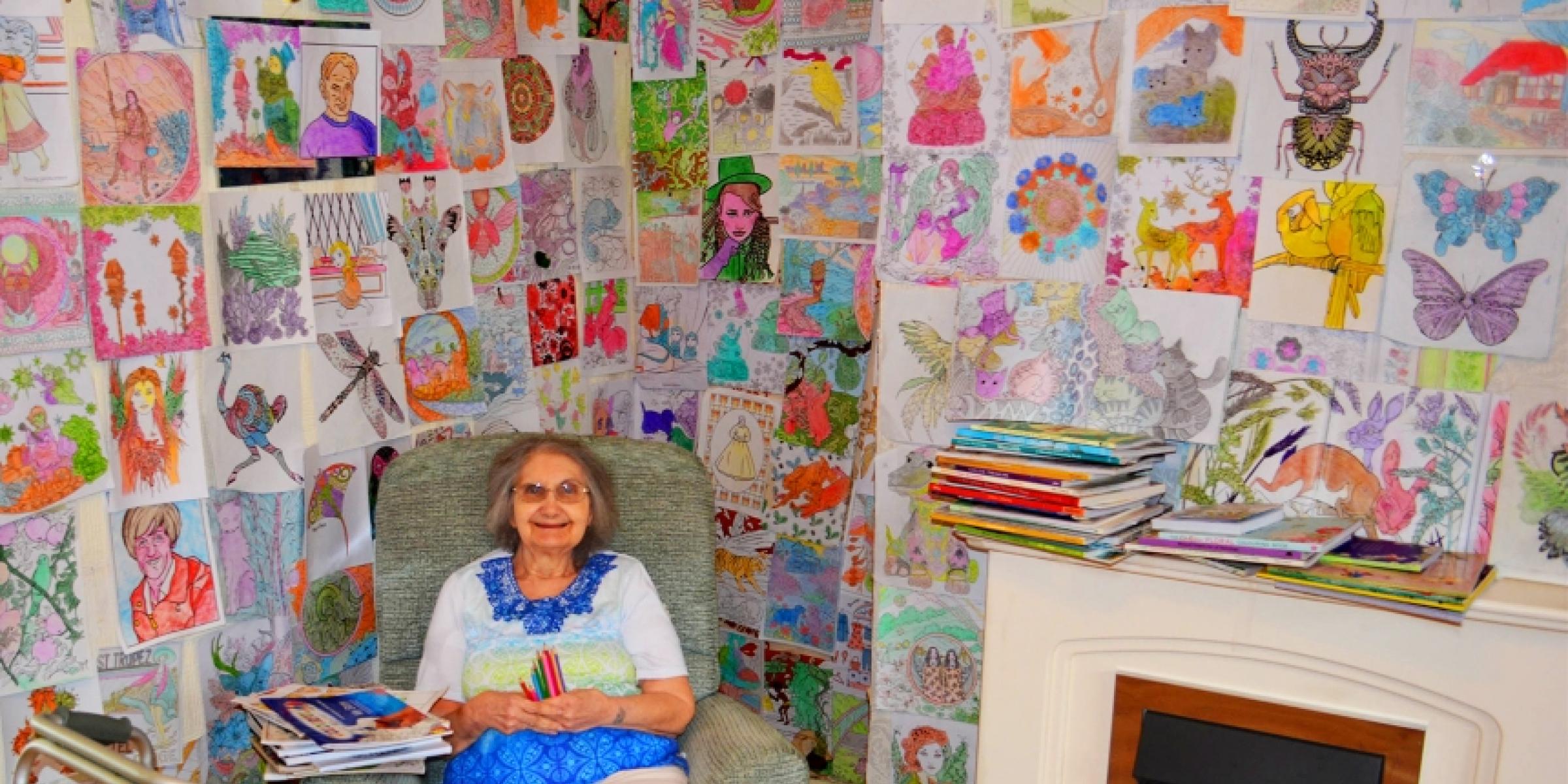 Jacqueline surrounded by her colouring pages