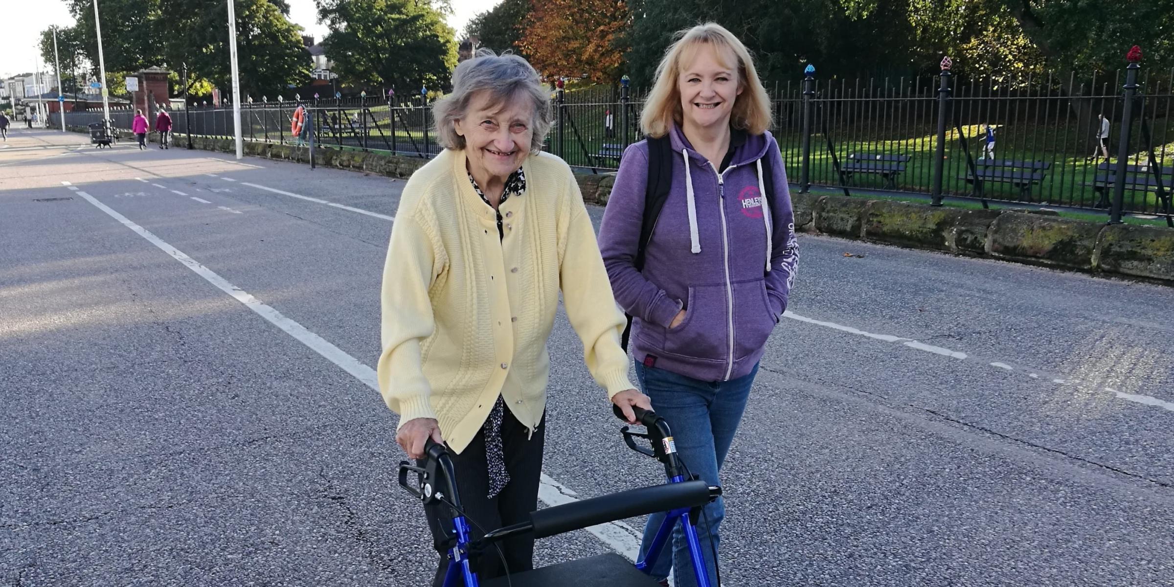 Kathy and her mother walking and smiling