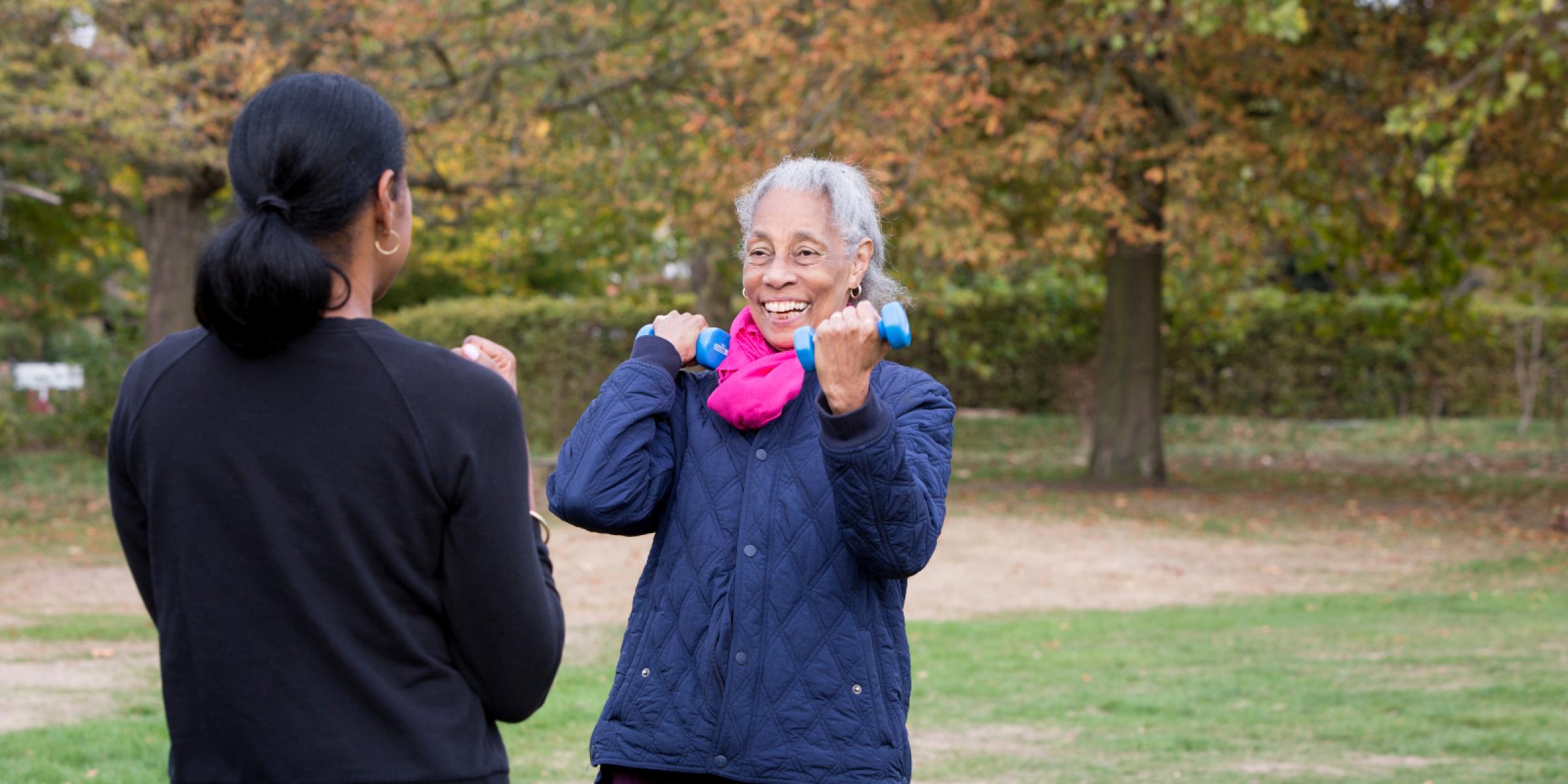 Daphne and Michelle outside in a park enjoying light exercise
