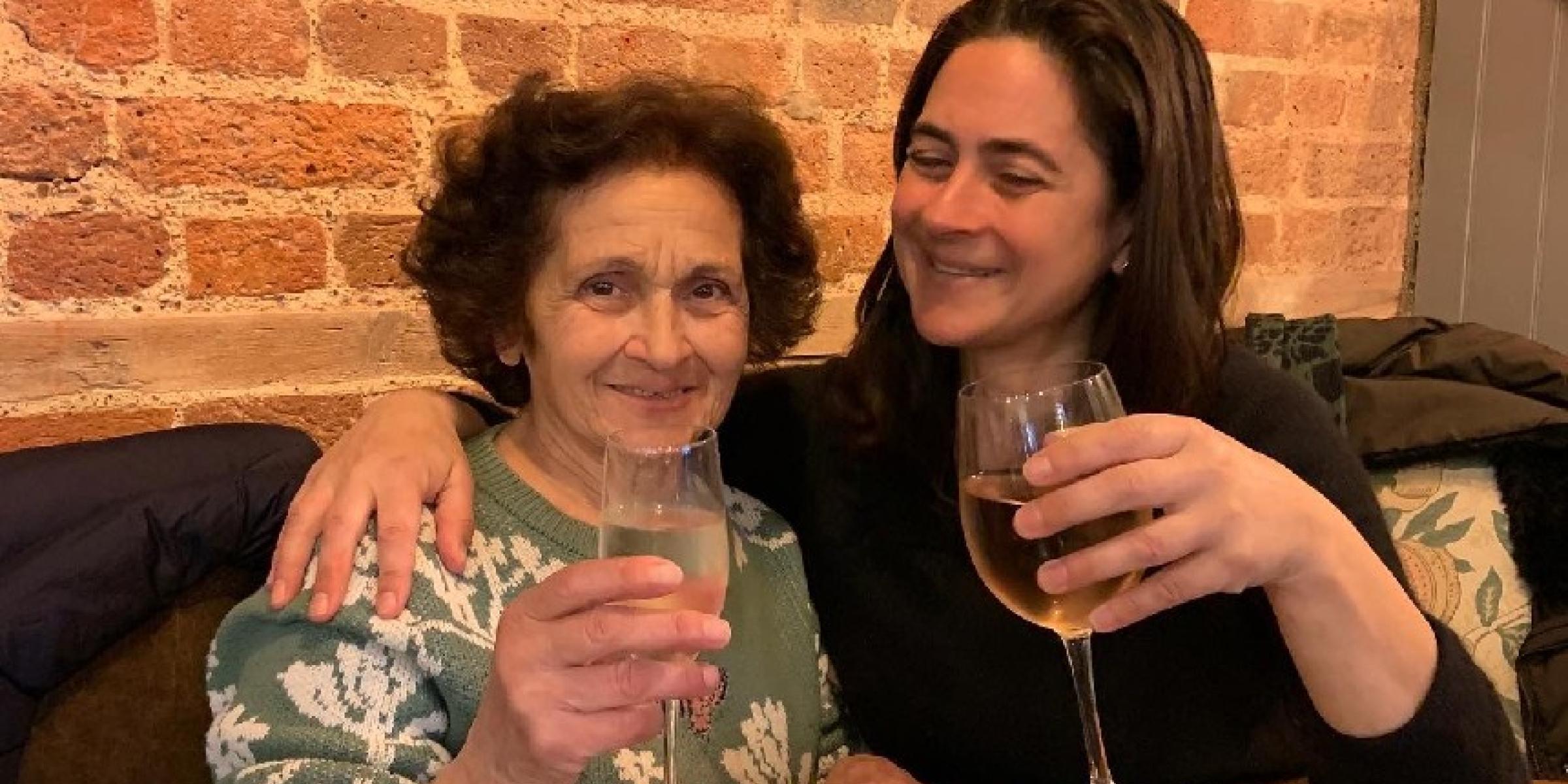 Zoe and Koula raising wine glasses