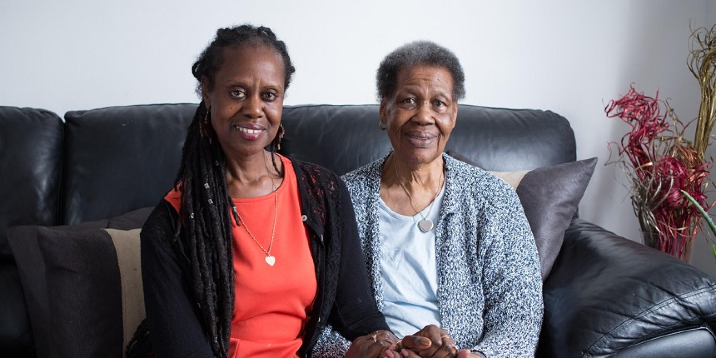 Enomwoyi sitting on the sofa with her mum, Pearl