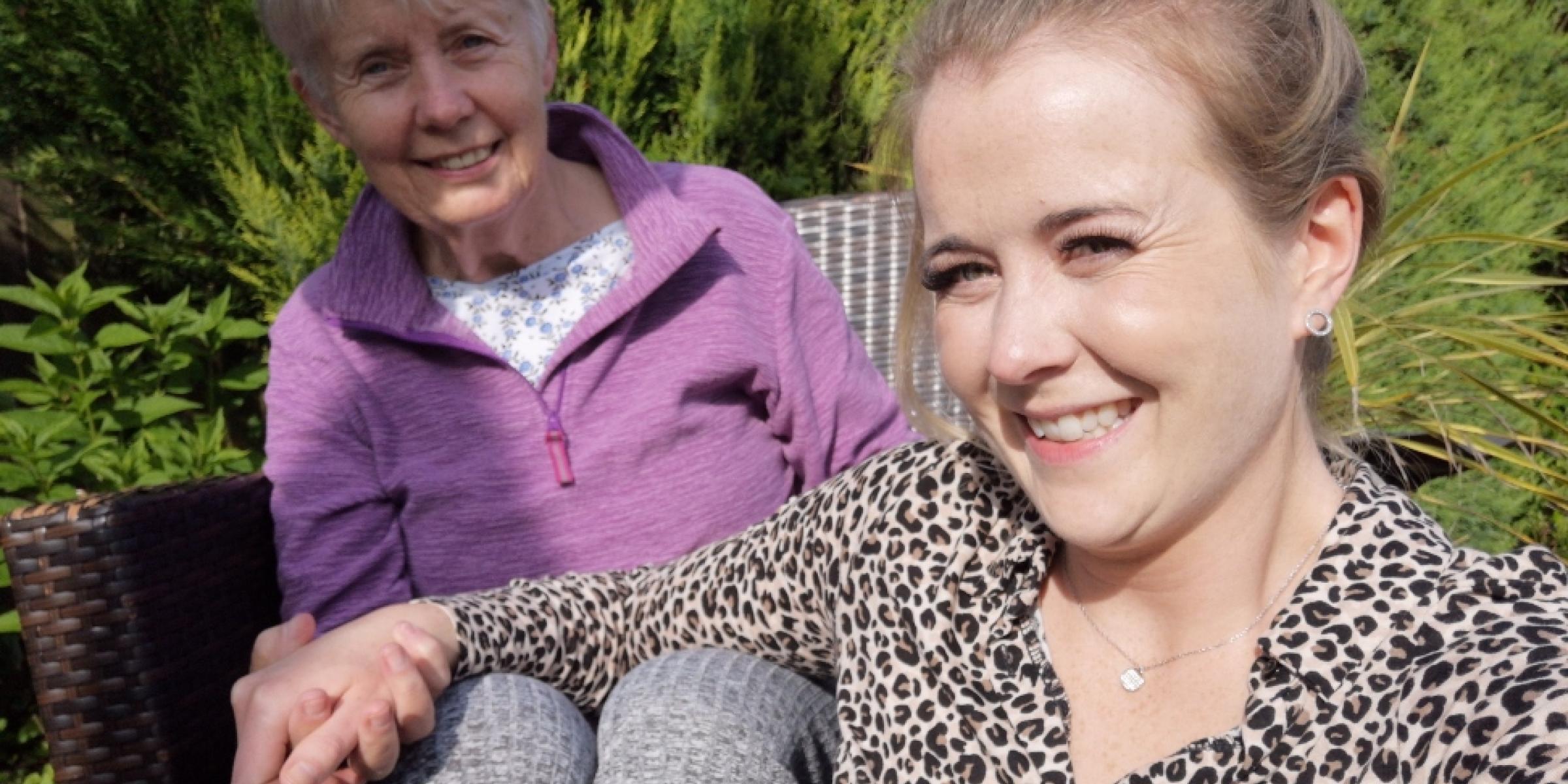 Lara and her mum, Sandee, taking a selfie in the garden, holding hands