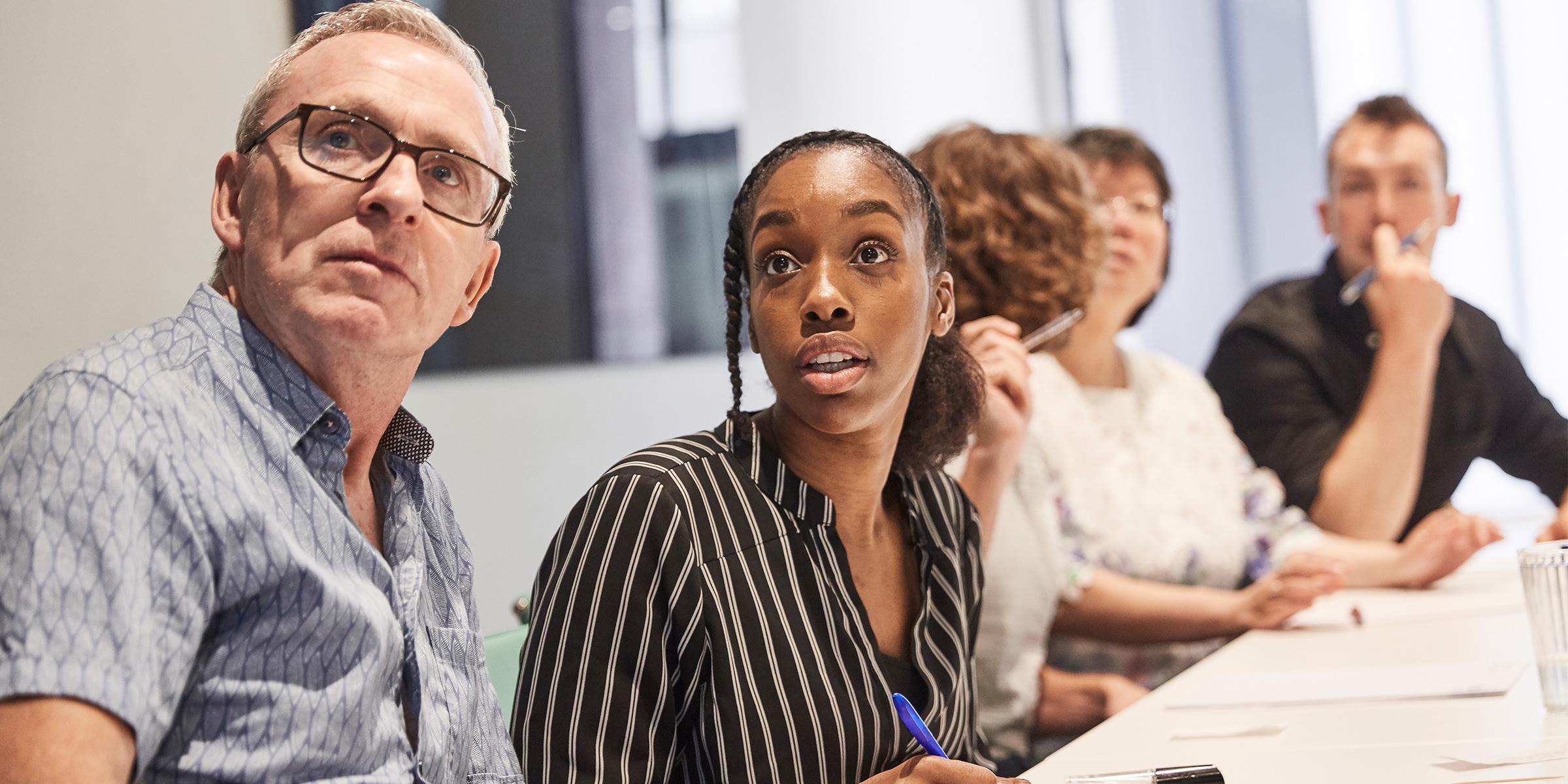 People sat at an Alzheimer's Society training course.