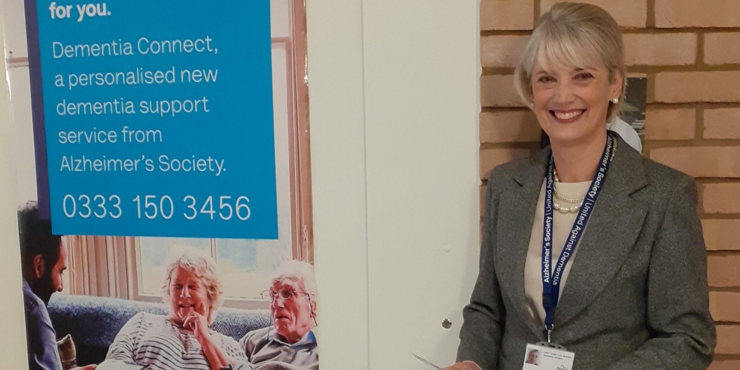 Hazel at a dementia information booth, handing out leaflets