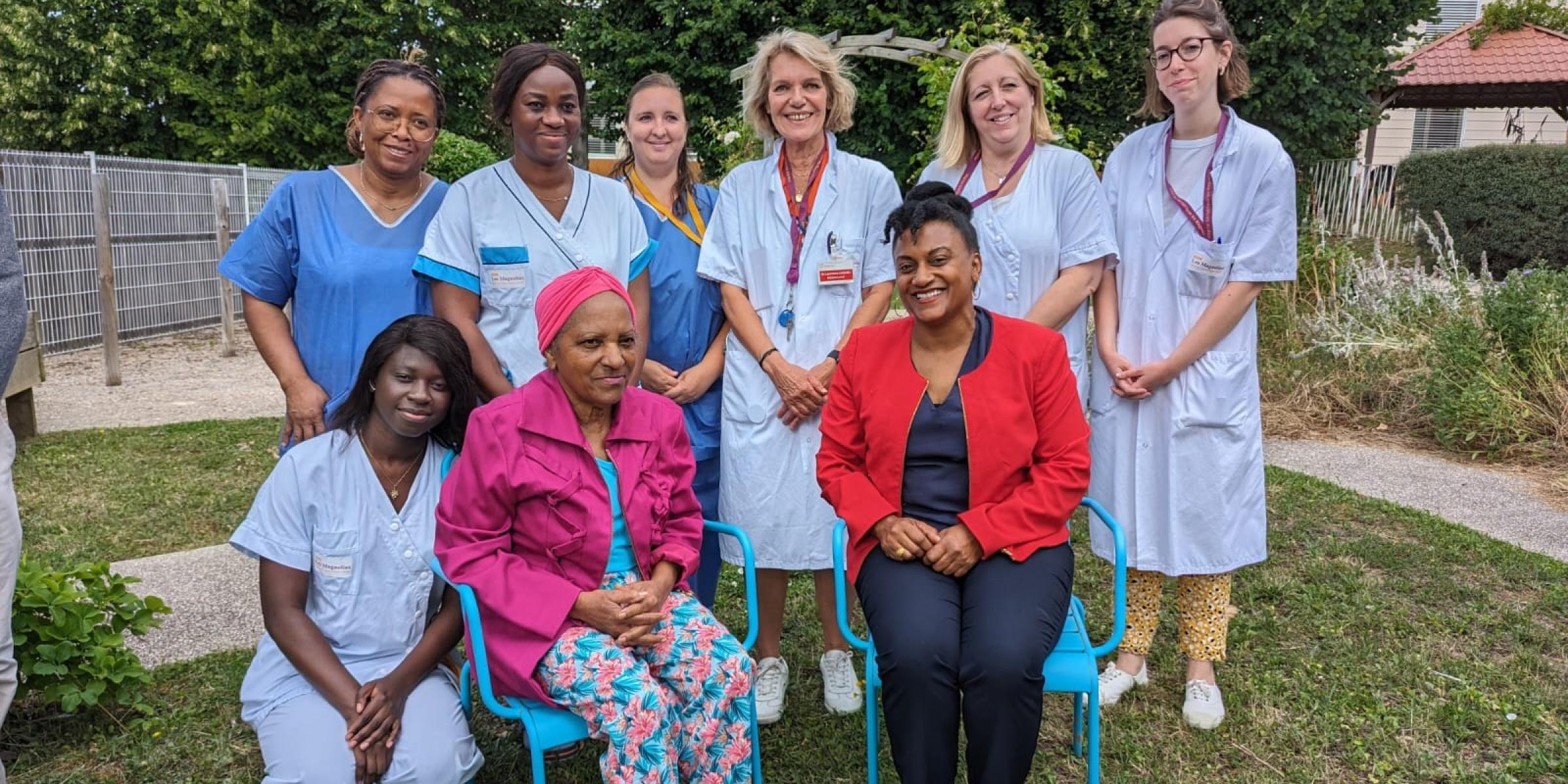 Armelle and Chantal sit surrounded by the Europa Care Home team