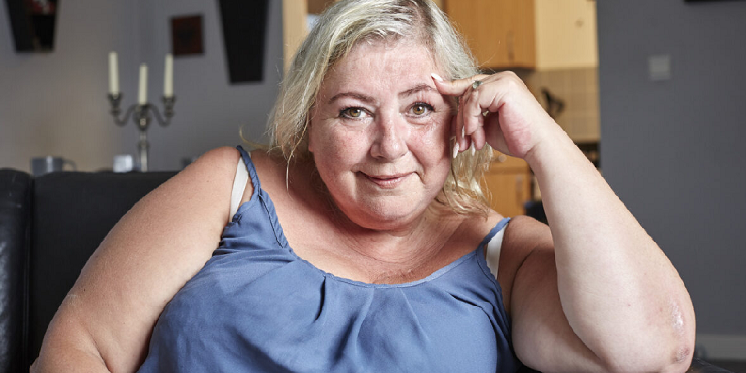 Anita on her sofa at home