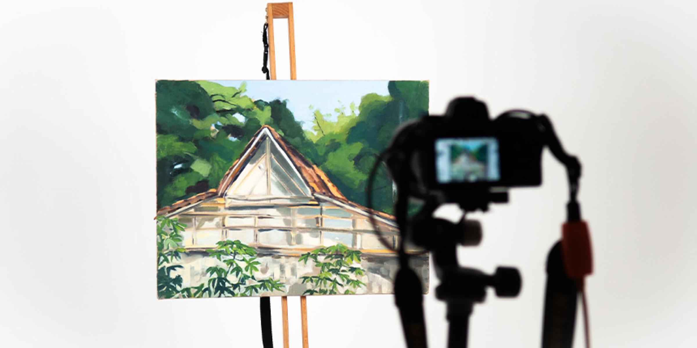 Painting being photographed on an easel