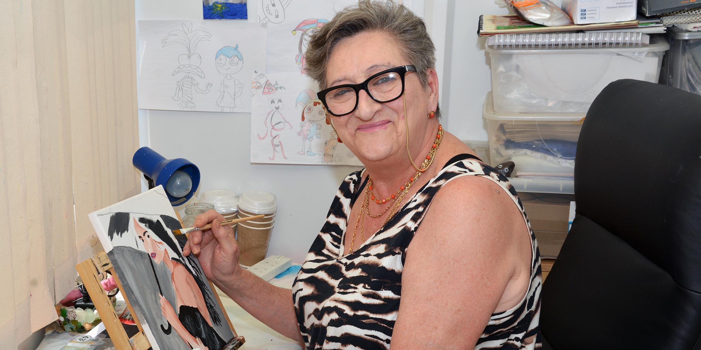 Maria painting a picture at home