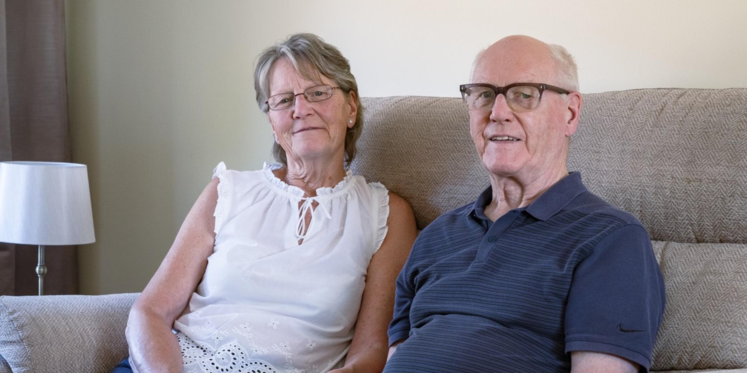 Liz and Jim Rose sat on their lounge sofa together