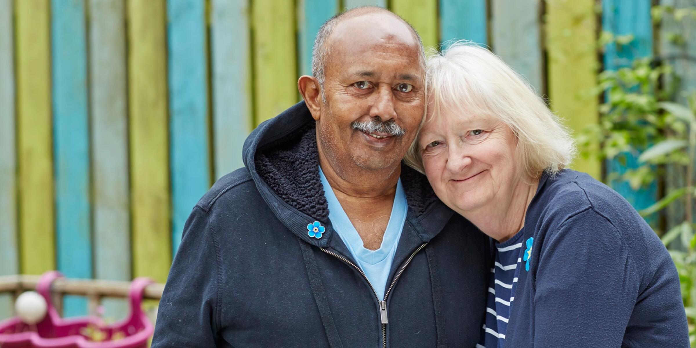 A couple leaning in to each other hugging