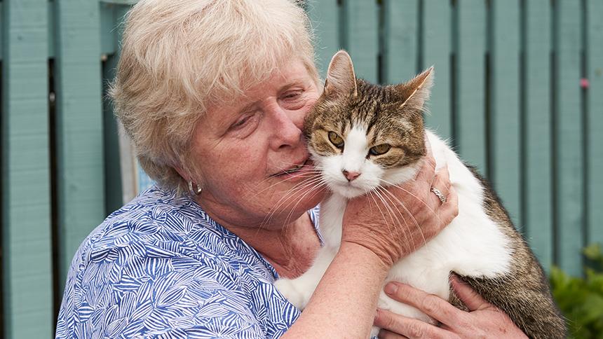 Chris Maddocks holding her pet cat.