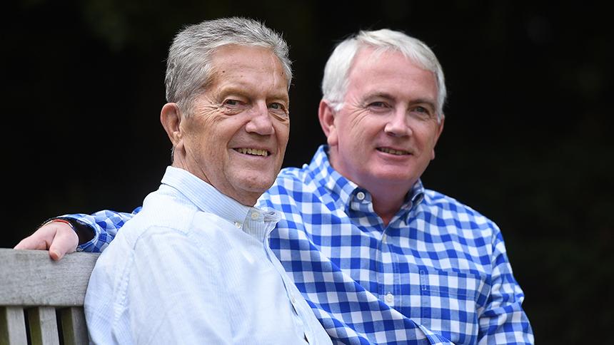 Elmar sitting outside with his partner David. 