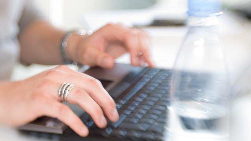 Someone using a computer keyboard