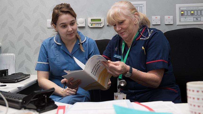 Staff at Teresa's Hospice reading information