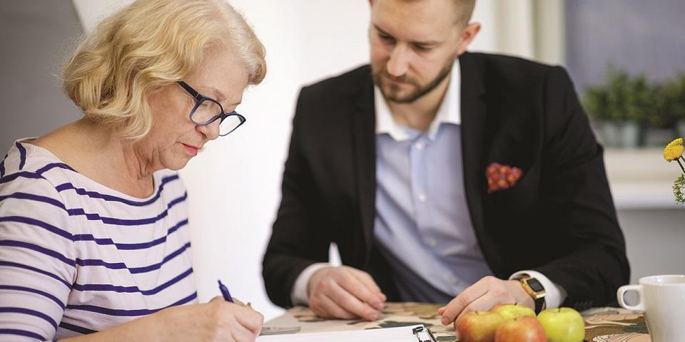 Woman sitting with a solicitor to talk about her Will