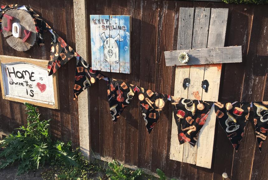 A wooden scarecrow wearing a bunting mask