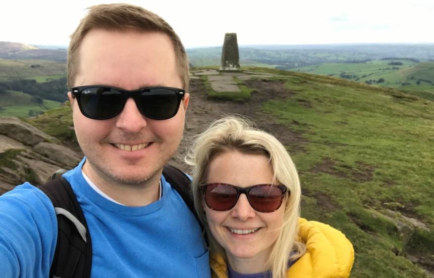 Sean Cullen standing in the countryside wearing sunglasses and smiling