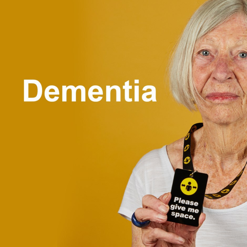 An older woman wearing a Please give me space lanyard