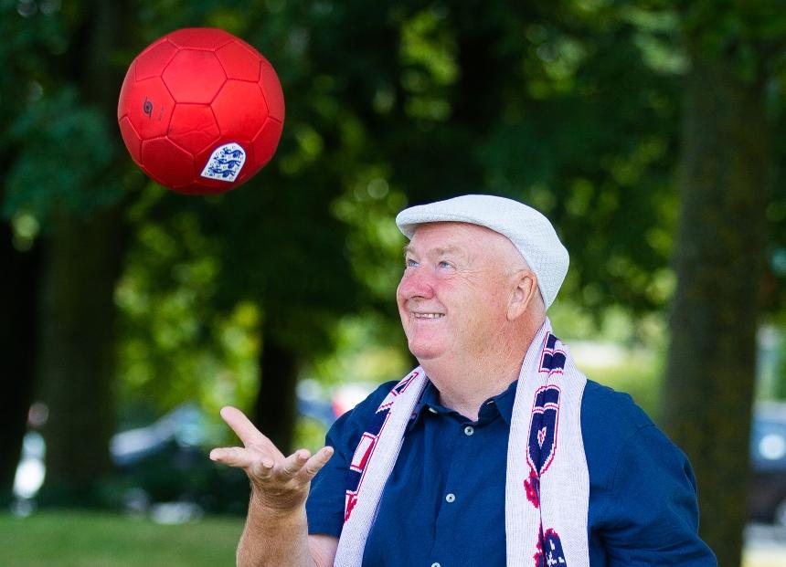 Tommy Dunne, throwing a red football