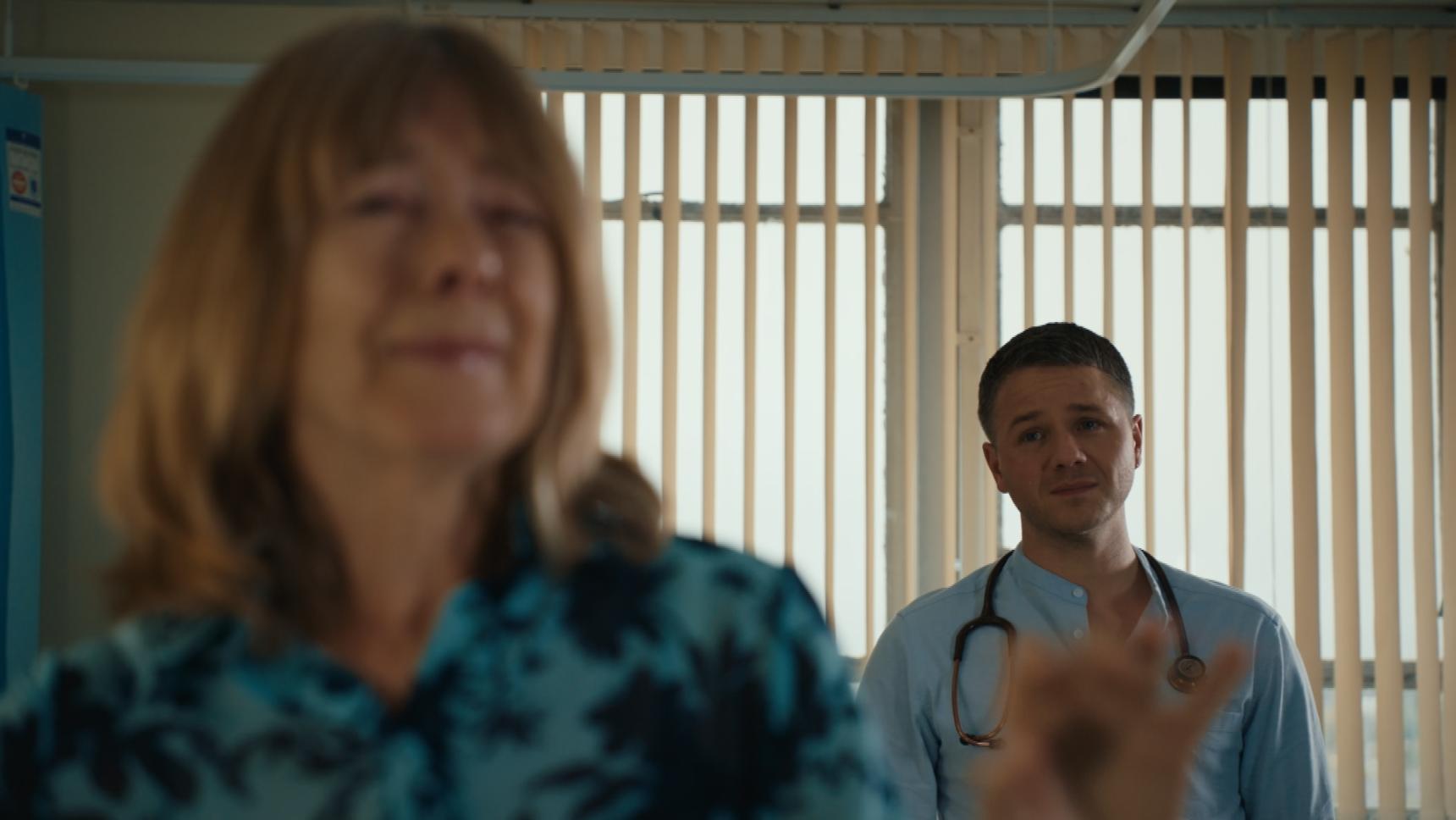 Carole Copeland out of focus in the foreground as her son Dom watches on