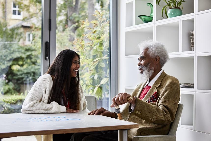 A young woman and an older man laughing together