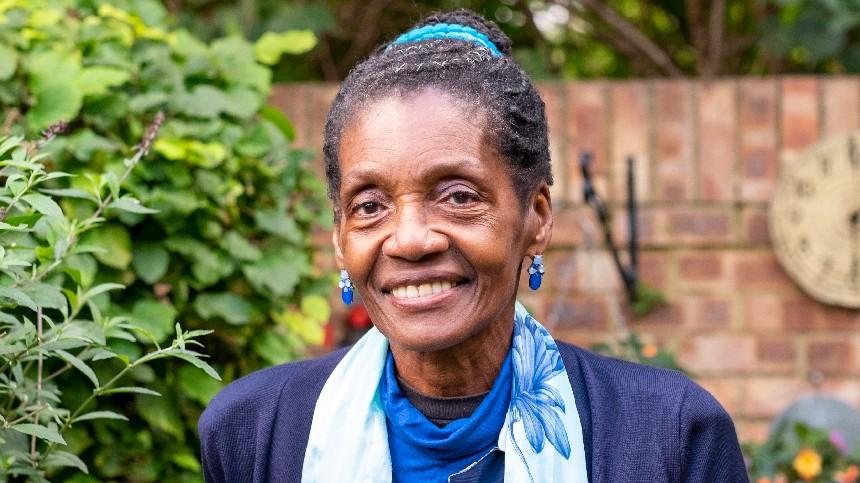 Morcea in her garden smiling to camera