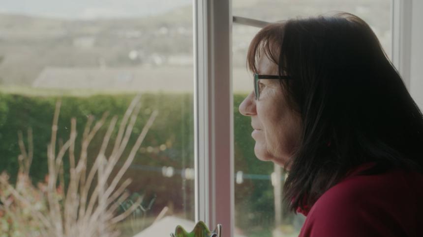 Gina looking out her window towards fields