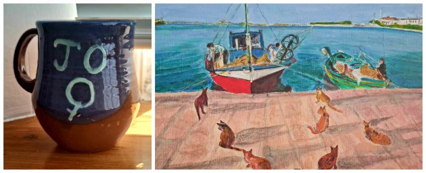 A blue mug that read 'Jo' with a symbol for woman, alongside a painting of a boat