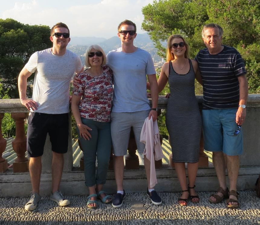 Lara, her brothers, dad and mum taking a family photo