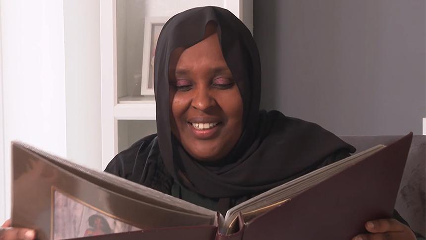 Samia looking at a photo album