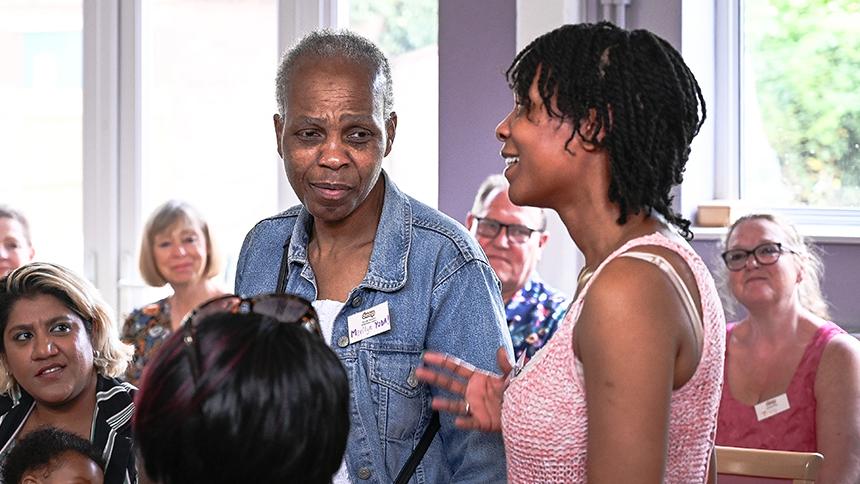 A daughter standing and speaking at a Young Onset Dementia Activists event.