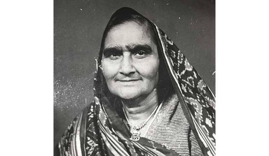 A black and white photograph of Lavina's Nani, Kasturben, wearing traditional dress