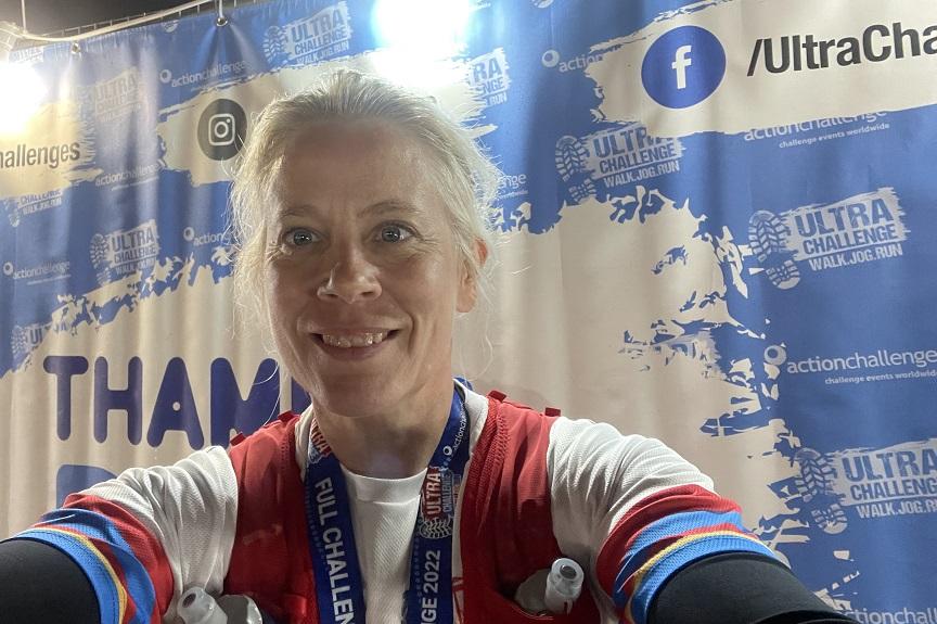 Judith Fowler wears her medal after completing the Thames Path Challenge 100K