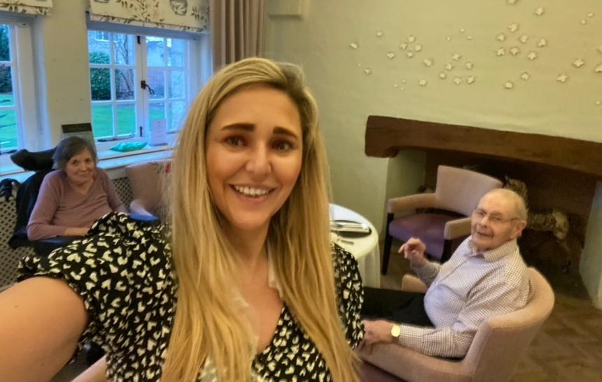 Carrie taking a photograph with her parents