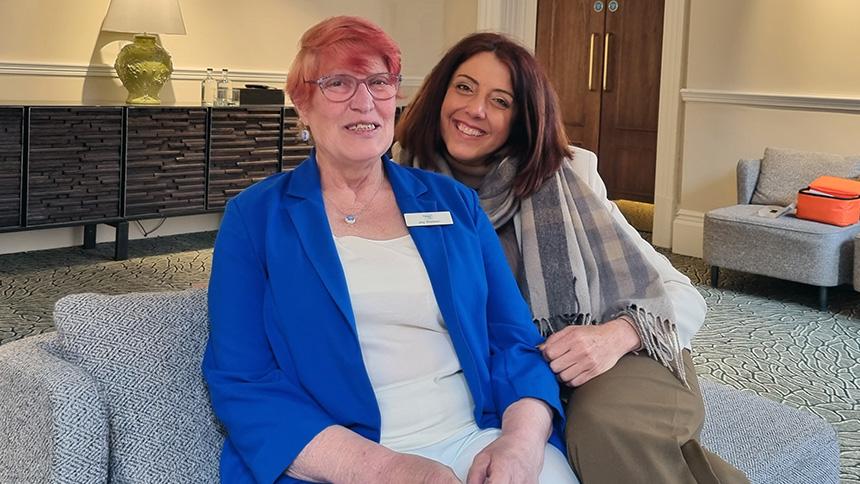 Joy Watson (left) sits with Kate Lee on a sofa