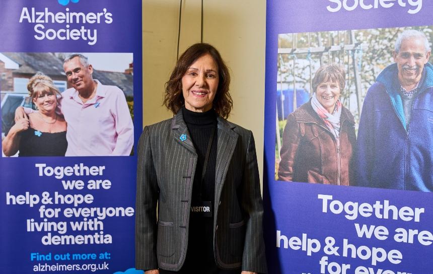 Dame Arlene Phillips in front of two Alzheimer's Society branded boards