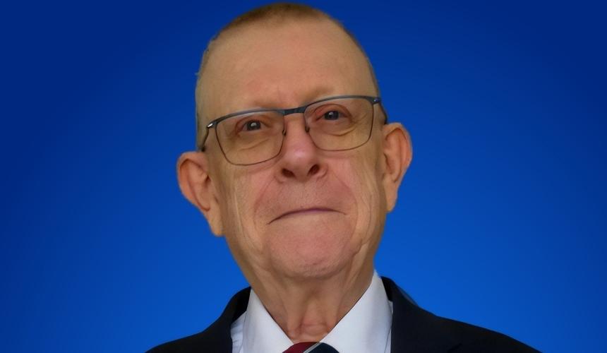 Image of Pete dressed up in a suit smiling at the camera